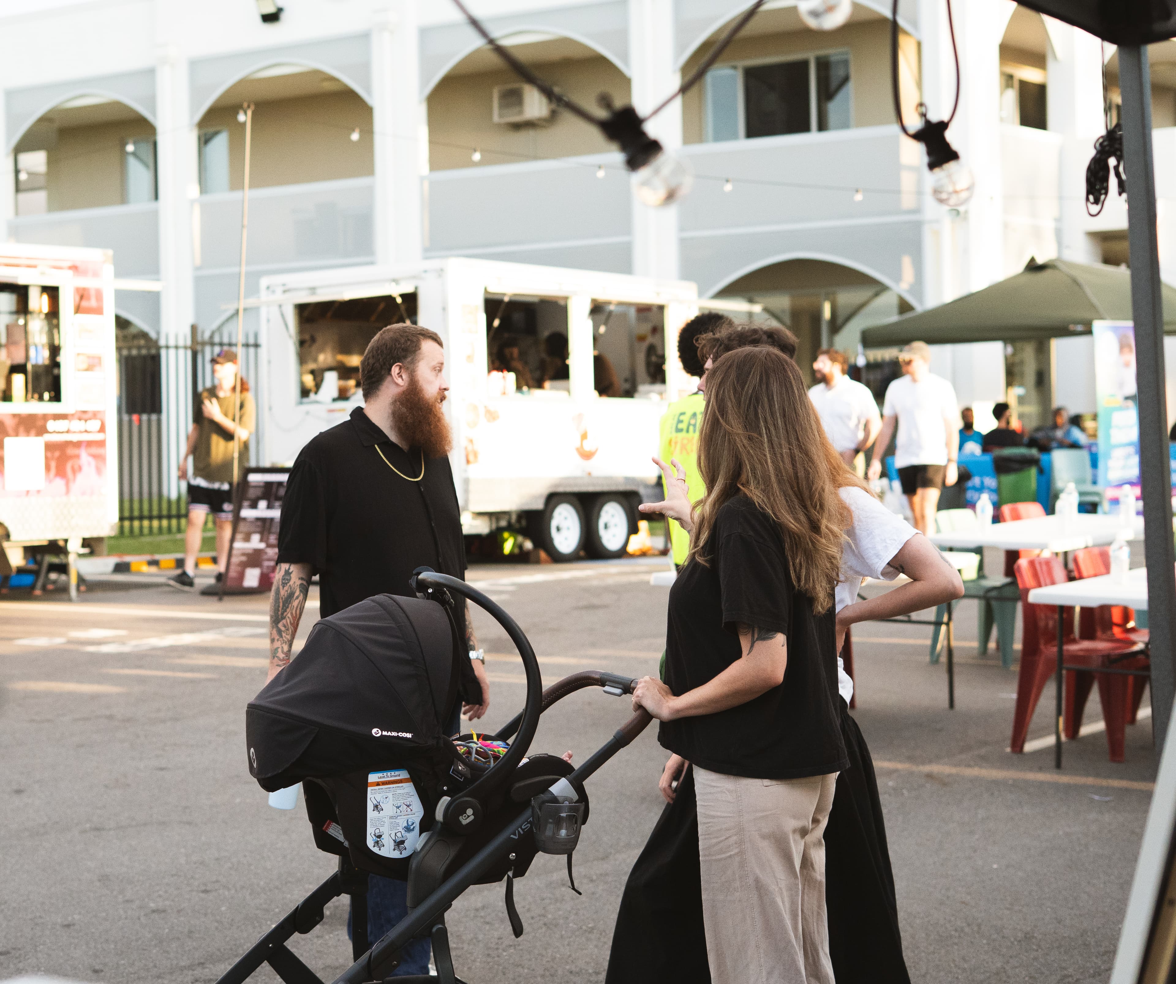 Crowds exploring food trucks at the market